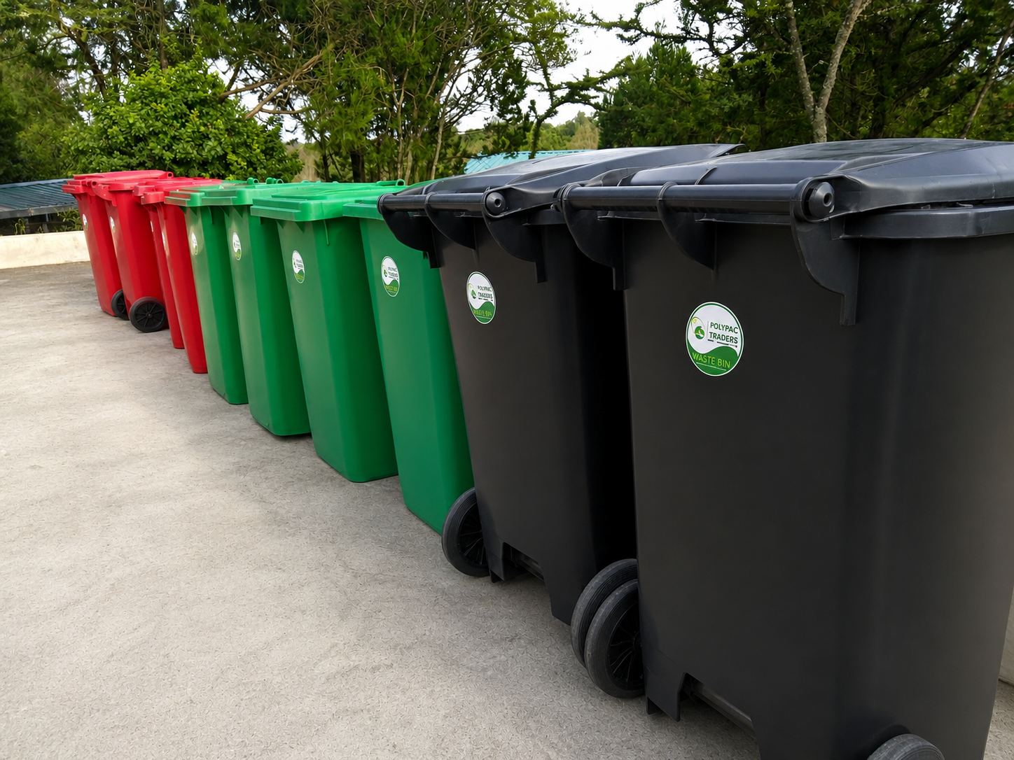 Rows of red, green, and black Polypac Traders waste bins